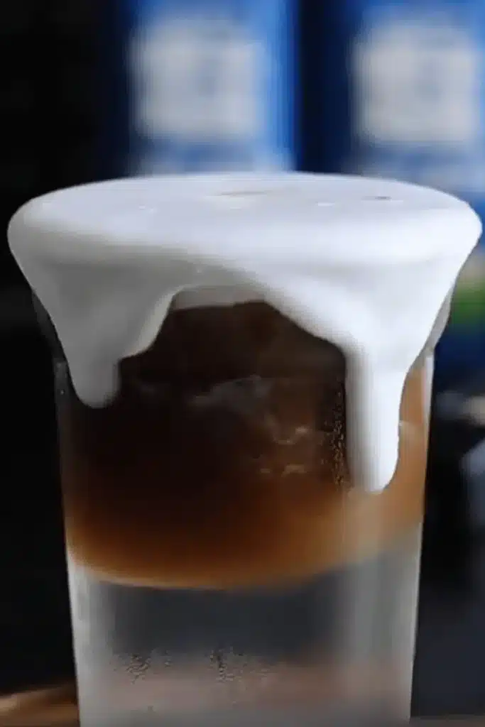 Coconut Cloud Coffee with creamy top dripping over espresso layer