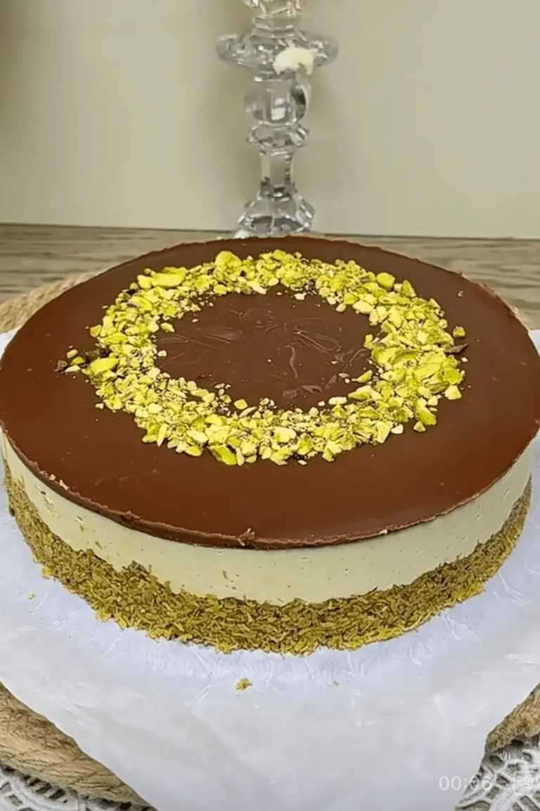 Dubai chocolate cheesecake with pistachio topping, shown whole on parchment paper
