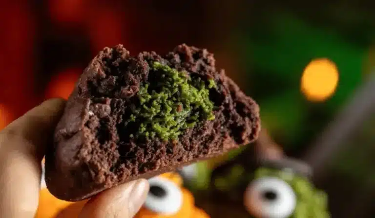 Inside of a cocoa Dubai chocolate cookie showing green pistachio kataifi center