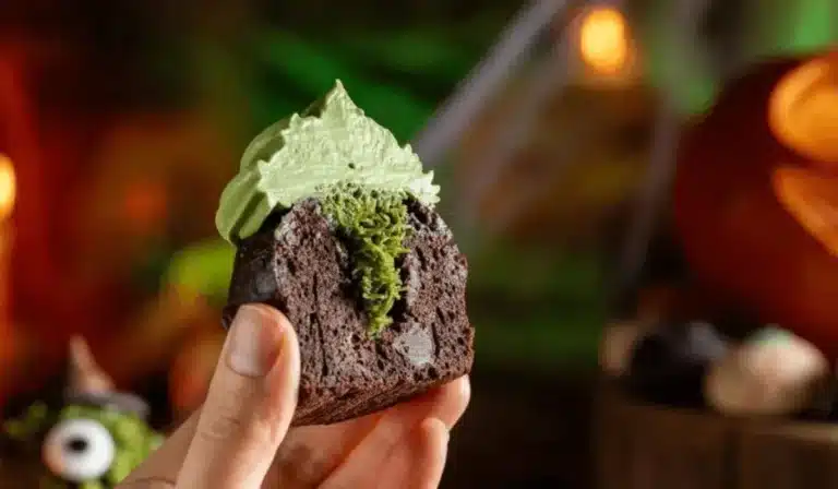 Cross-section of Dubai chocolate cupcake with pistachio frosting and crunchy green kataifi filling