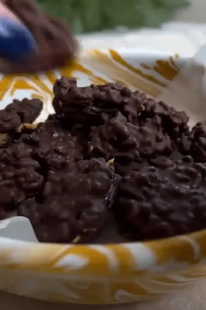 Bowl of date snickers filled with peanut butter and coated in melted chocolate with puffed rice mixed in