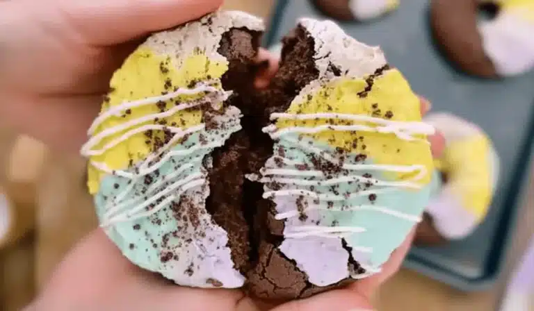 Moonbeam Ice Cream Crumbl Cookie broken in half with vibrant frosting