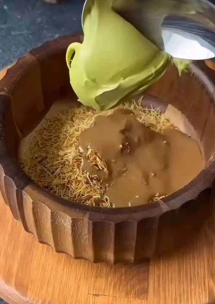 Mixing shredded kataifi and pistachio butter for Dubai chocolate dates