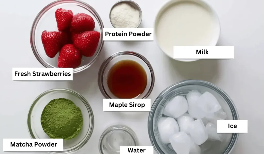Strawberry matcha latte ingredients including matcha powder, strawberries, milk, and protein