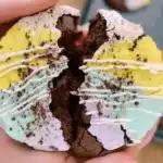 Crumbl Copycat Cookie broken in half with vibrant frosting